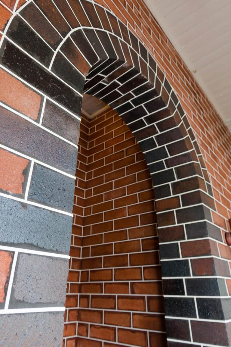 Close-up of tuckpointed brick wall with new mortar joints.